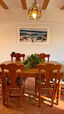 a dining room with a wooden table and chairs at Precioso chalet en la playa de Tavernes de la Valldigna in Tavernes de Valldigna