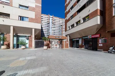 an empty street in a city with tall buildings at Travel Habitat Palau De Les Arts in Valencia