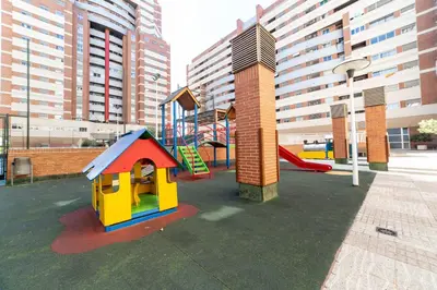 a playground with a slide and a play structure at Travel Habitat Palau De Les Arts in Valencia