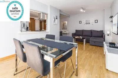 a living room with a table and chairs and a couch at Travel Habitat Palau De Les Arts in Valencia