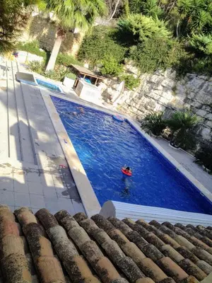 a person swimming in a large blue swimming pool at El Collado in Cullera