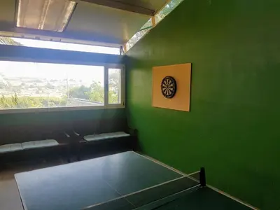 a green room with a table and a window at El Collado in Cullera