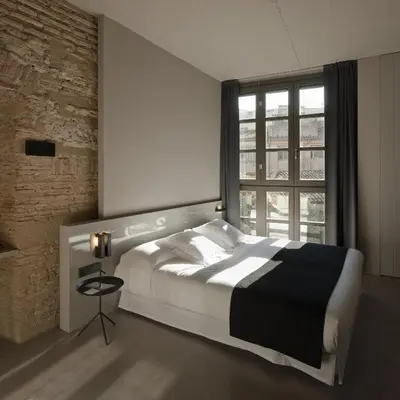 a bedroom with a large bed and a window at Caro Hotel in Valencia
