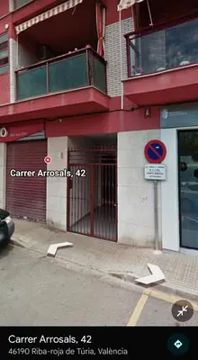 a building with a gate on the side of a street at Apartamento Cerca De Valencia in Riba-Roja De Turia