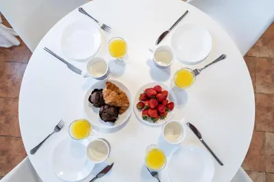 a table with plates of food and glasses of orange juice at My Loft 4 You Temple in Valencia