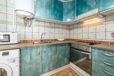 a kitchen with blue cabinets and a sink and a microwave at My Loft 4 You Temple in Valencia