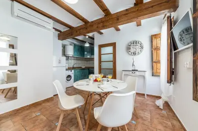 a kitchen and dining room with a white table and chairs at My Loft 4 You Temple in Valencia