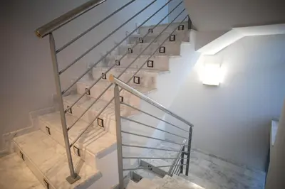 a staircase with wooden steps and a light on the wall at El Chalet in Cullera