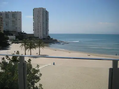 a view of a beach with buildings and the ocean at El Chalet in Cullera