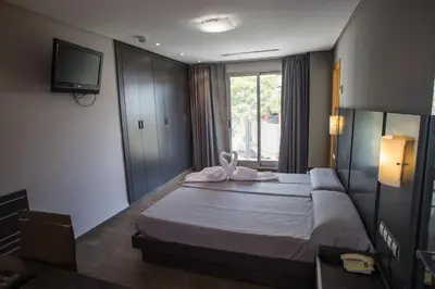 a hotel room with a bed with a towel on it at El Chalet in Cullera