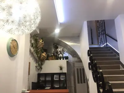 a stairway with a clock and a clock at Hostal Boutique Luna de Gavín in Cullera