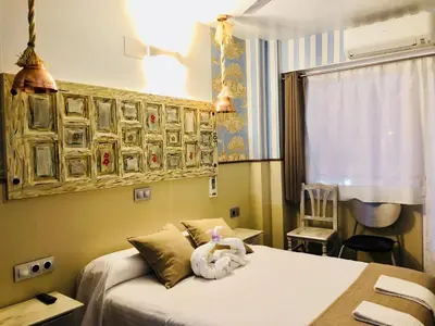 a hotel room with a bed with towels on it at Hostal Boutique Luna de Gavín in Cullera
