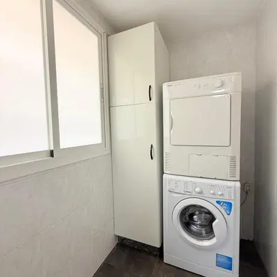 a laundry room with a washer and dryer in it at Travel Habitat Mestalla in Valencia