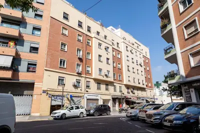 a city street with cars parked in front of buildings at Travel Habitat Mestalla in Valencia