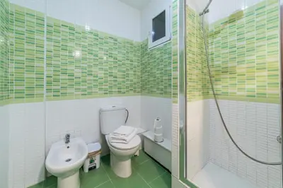 a bathroom with a toilet and a sink and a shower at Travel Habitat Mestalla in Valencia