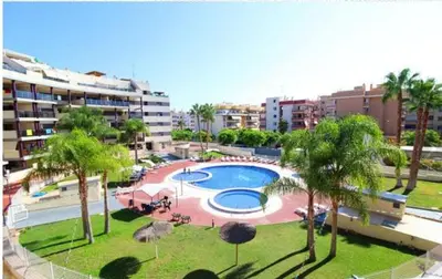 a kitchen and a living room with a table and chairs at WONDERFUL APARTMENT IN CANET DE BERENGUER. VALENCIA in Valencia