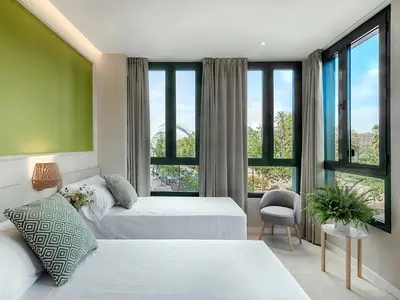 a hotel room with two beds and a large window at Opera House Valencia B&B in Valencia