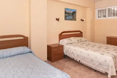 two beds in a room with two beds sidx sidx sidx at Mar y Montaña, 2º-18 in Cullera