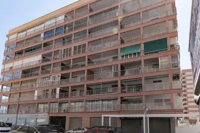 an apartment building with cars parked in front of it at Estrella, 2º-10 in Cullera