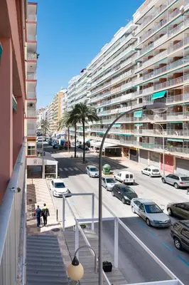 a street with cars parked in a parking lot at Estrella, 2º-10 in Cullera