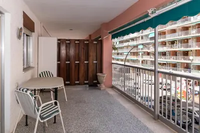 a balcony with a table and chairs in a library at Estrella, 2º-10 in Cullera