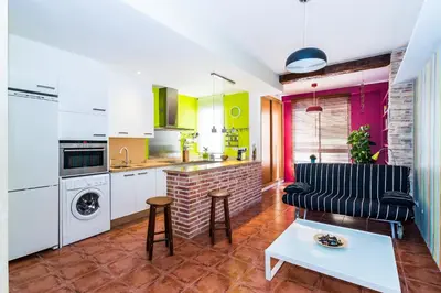 a kitchen with a living room with a table at Fun&Happy VLC Center in Valencia