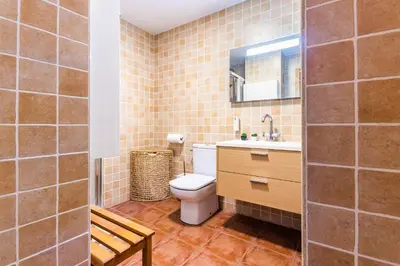 a bathroom with a toilet and a sink and a mirror at Fun&Happy VLC Center in Valencia