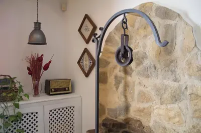 a room with a stone wall with headphones hanging from it at Hostal El Pozo in Chulilla