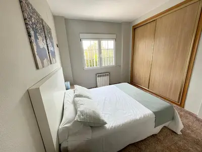a bedroom with a white bed and a window at Casa Maica in Lliria