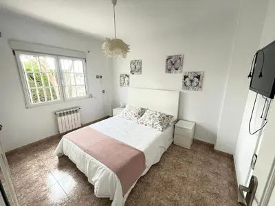 a bedroom with a bed and a window at Casa Maica in Lliria