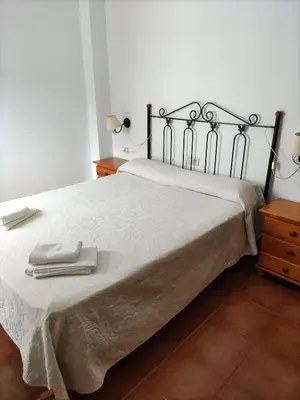 a bedroom with a bed with two towels on it at La Rueda Apartamentos Rurales in Chulilla
