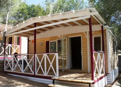 a small house with awning on a porch at Camping Santamarta in Cullera