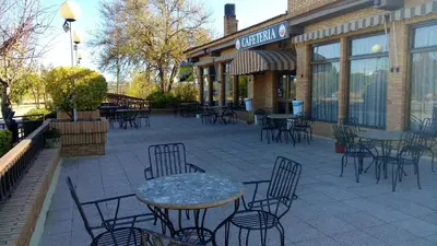 a patio with tables and chairs outside of a restaurant at Hotel-Motel Sol II in Requena