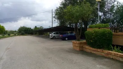 a parking lot with two cars parked in it at Hotel-Motel Sol II in Requena