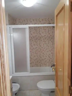 a bathroom with a toilet and a bath tub at Atico Duplex 1ª in Xilxes