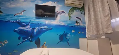 a bedroom with a mural of dolphins in the ocean at A123 ViviendaTuristicaValencia Grandes Grupos in Valencia
