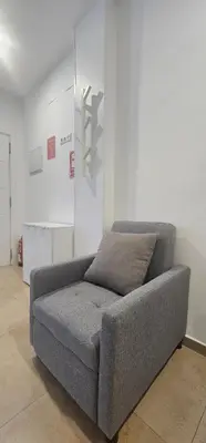 a gray couch sitting in a room at A123 ViviendaTuristicaValencia Grandes Grupos in Valencia