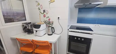 a kitchen with a counter and a stove top oven at A123 ViviendaTuristicaValencia Grandes Grupos in Valencia