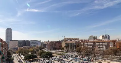 a city with cars parked in a parking lot at Casa De La Luz in Valencia