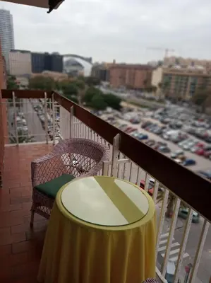 a table on a balcony with a view of a harbor at Casa De La Luz in Valencia