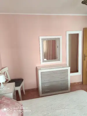 a bedroom with a dresser and a mirror on the wall at Mari Carmen, 2º-8 in Cullera