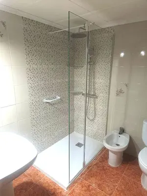 a bathroom with a glass shower and a toilet at Mari Carmen, 2º-8 in Cullera