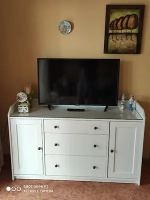 a white dresser with a flat screen tv on top of it at Mari Carmen, 2º-8 in Cullera