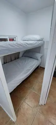 a bedroom with two bunk beds in a room at Camping Barraquetes in Sueca