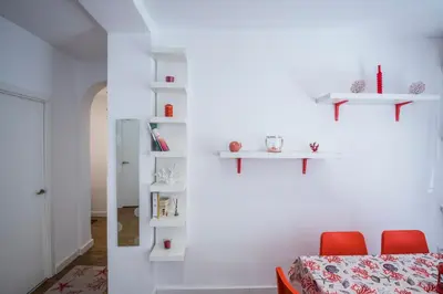 a room with red chairs and white shelves at El Coral Apartment Valencia in Valencia