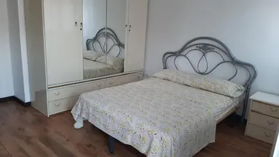 a bedroom with a bed and a large mirror at Burriana in Burriana
