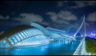 a view of a building with blue lights at night at La casita azul de la playa in Valencia