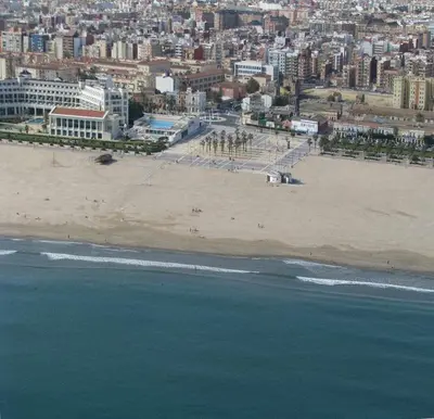 a view of a beach with a city in the background at Malvarrosa Calle Pavia in Valencia
