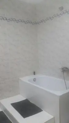 a white bathroom with a tub and a sink at Malvarrosa Calle Pavia in Valencia