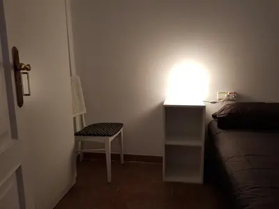 a room with a bed and a desk with a light at Malvarrosa Calle Pavia in Valencia